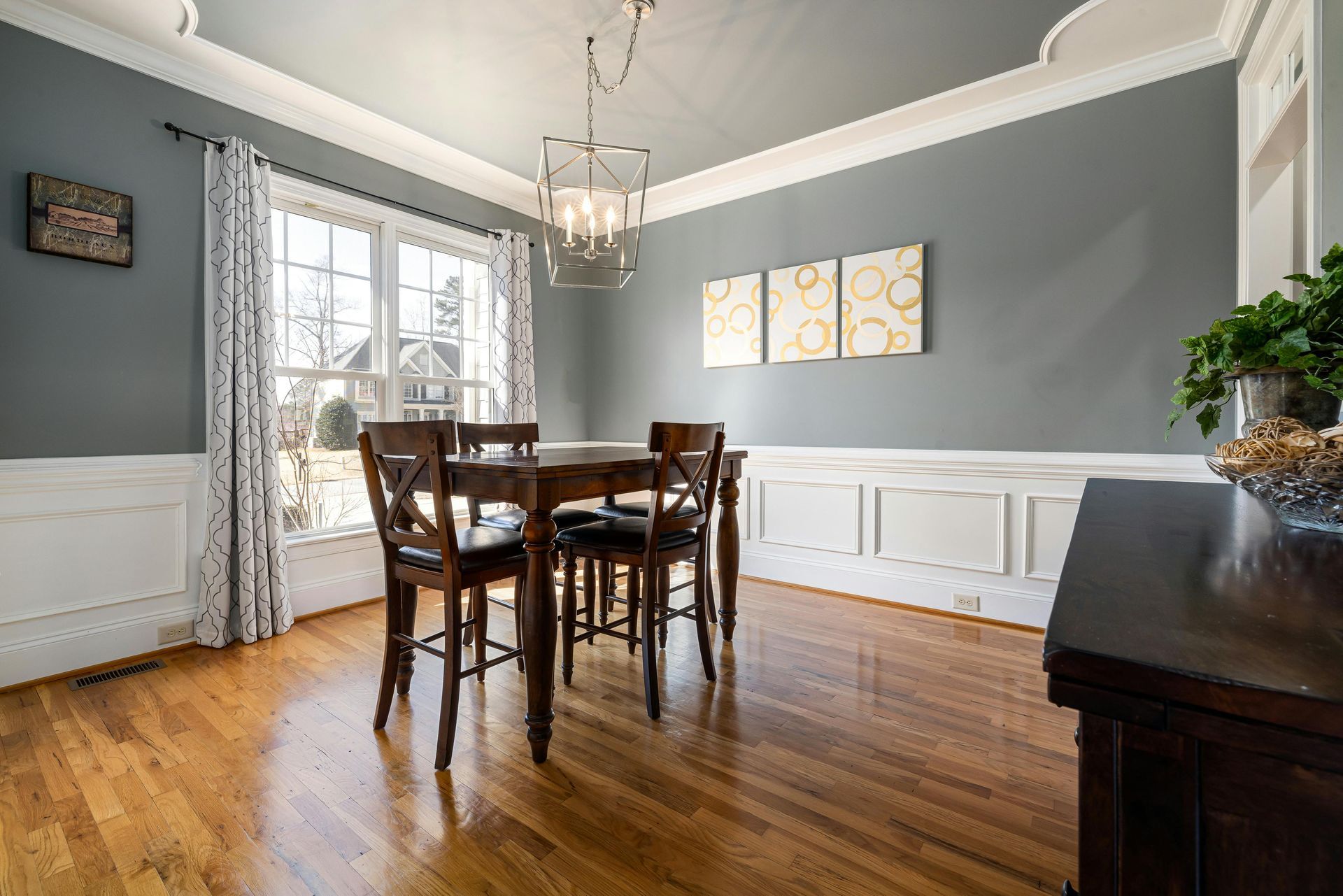 A dining room with a table and chairs and a chandelier.