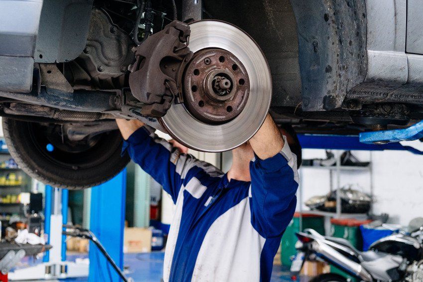 Man Repairing Car At Auto Repair Shop
