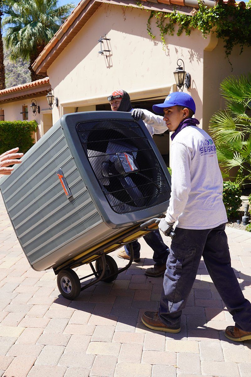 All Seasons Team Member transporting A?C Unit