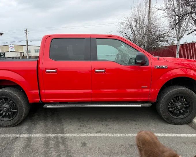 Red Ford F-150 with tinted windows, detailed by Perfection Plus Auto Salon