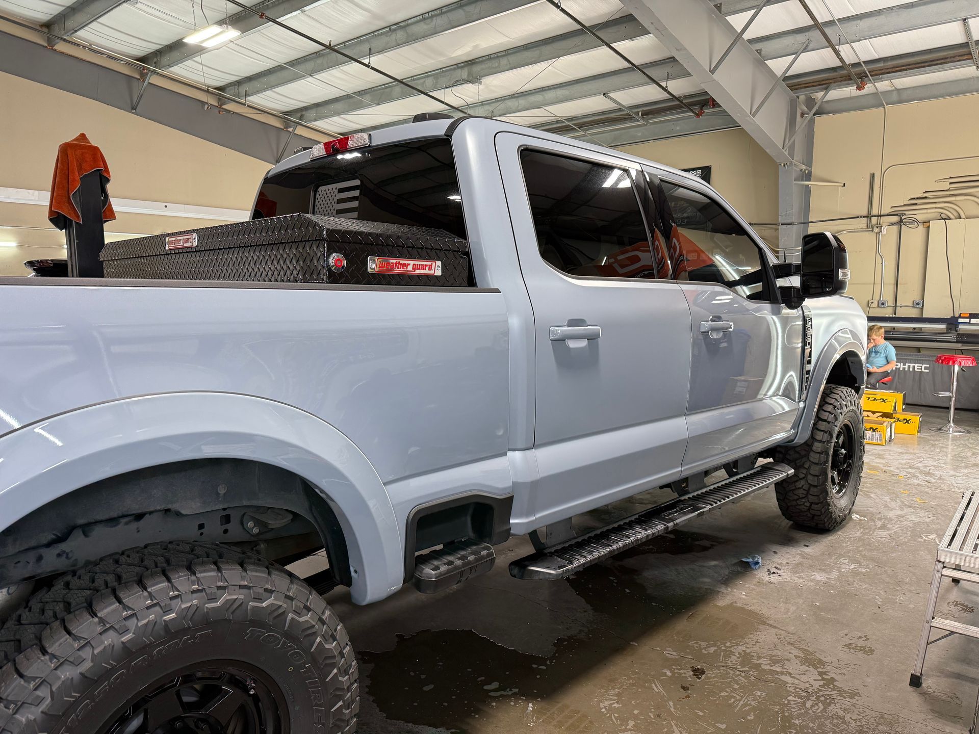 A gray pickup truck is parked in a garage.