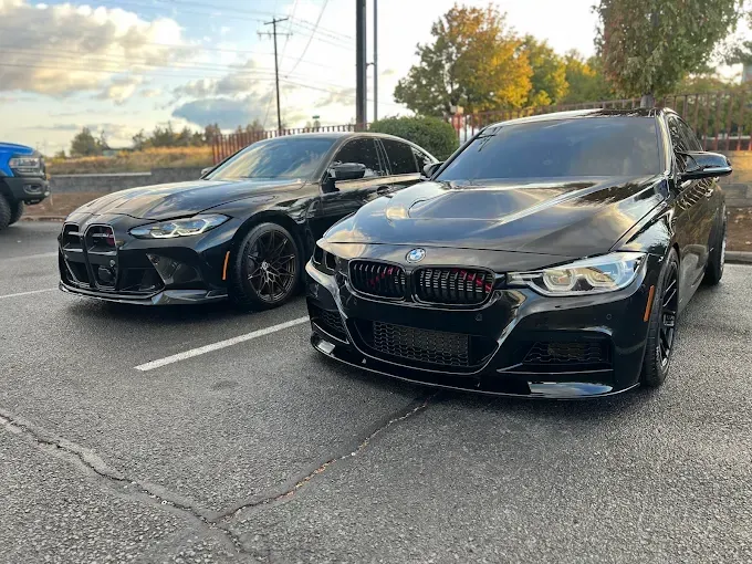 Two black BMWs with glossy finishes, highlighting PPF protection. 