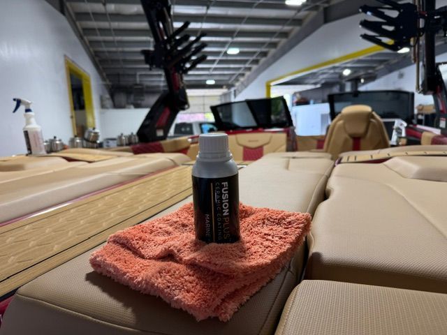 A bottle of polish sits on a towel on a boat