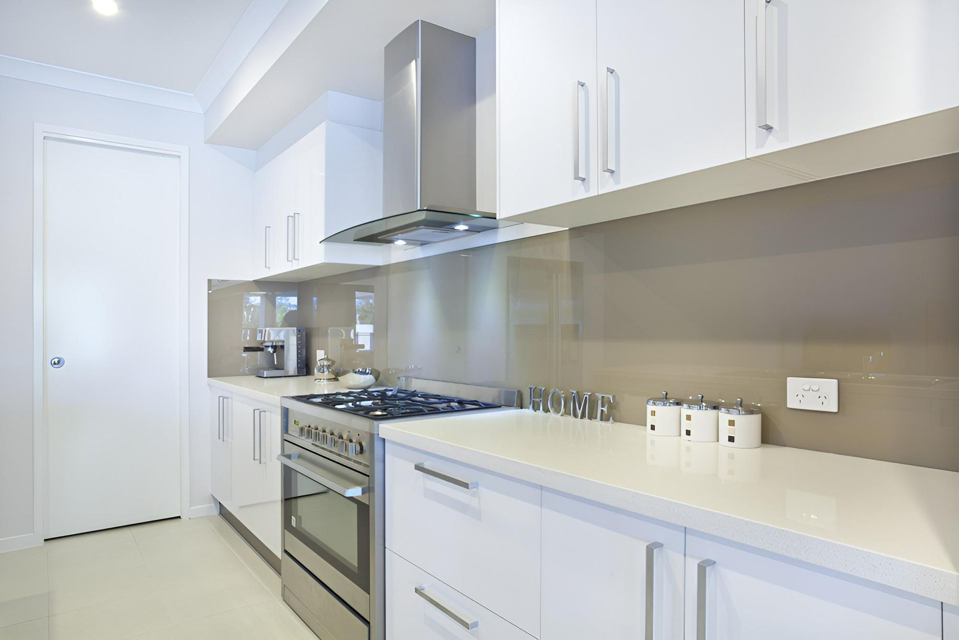 A Kitchen With White Cabinets and Stainless Steel Appliances — Precision Kitchens & Cabinets in Yamba, NSW