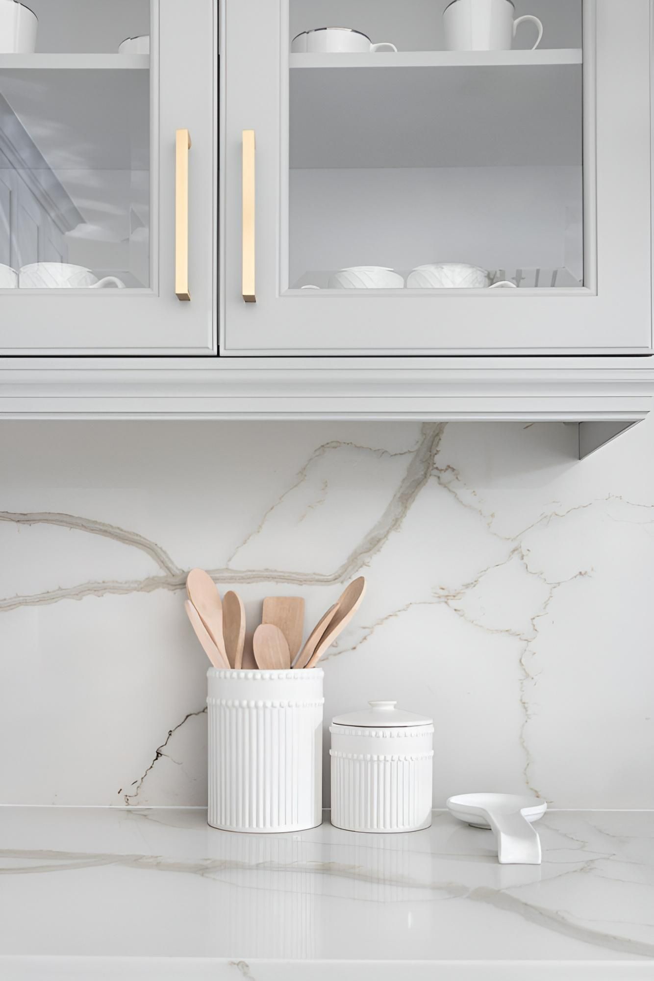 A Kitchen Counter With a Container of Wooden Utensils on It — Precision Kitchens & Cabinets in Ballina, NSW