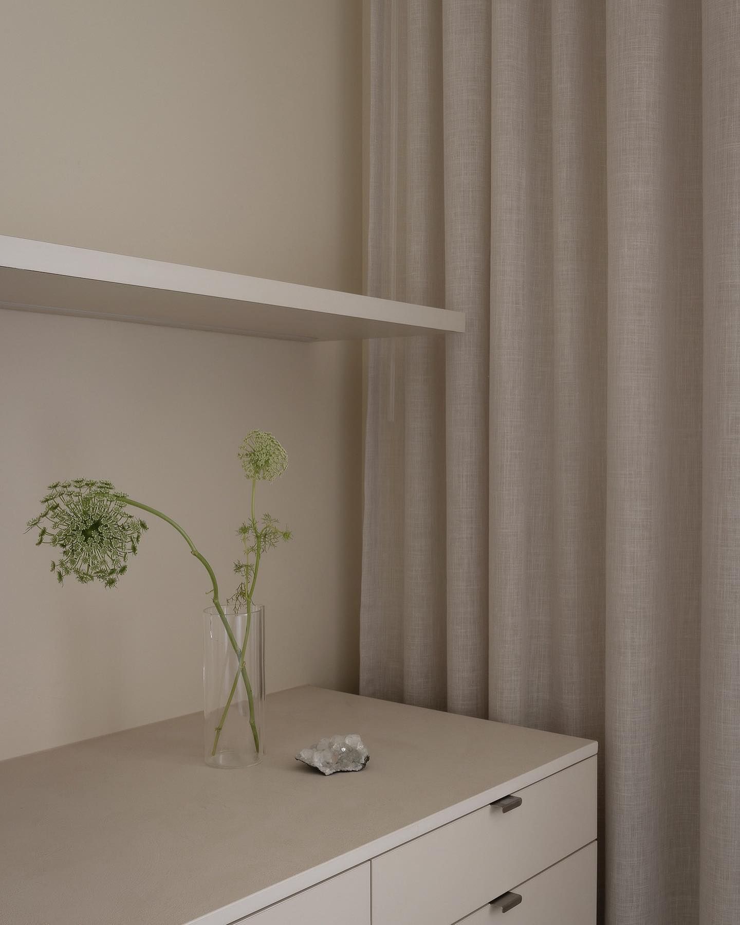 A Vase of Flowers is Sitting on a Table Next to a Shelf — Precision Kitchens & Cabinets in Ballina, NSW