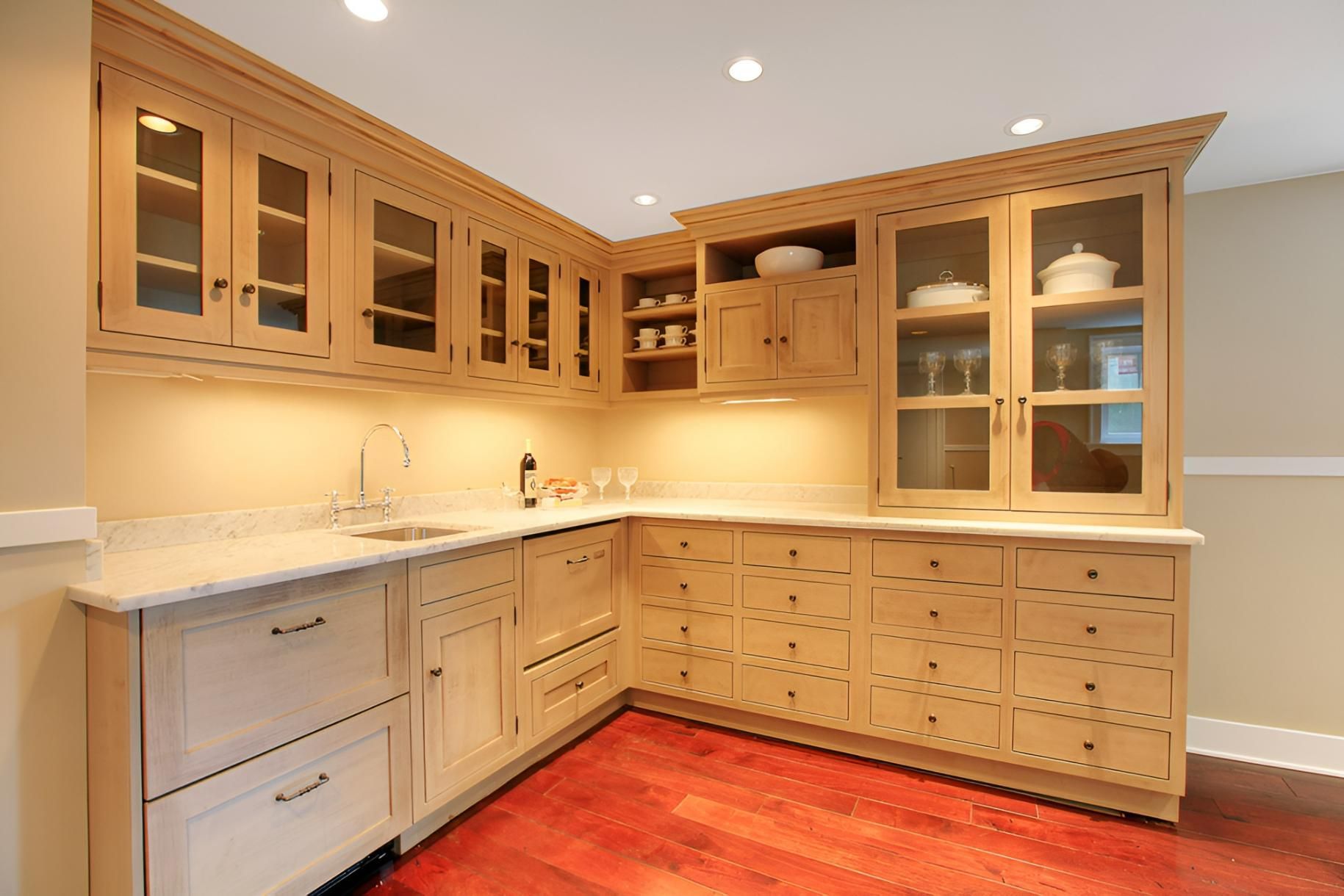 A Kitchen With Wooden Cabinets and Granite Counter Tops — Precision Kitchens & Cabinets in Bangalow, NSW