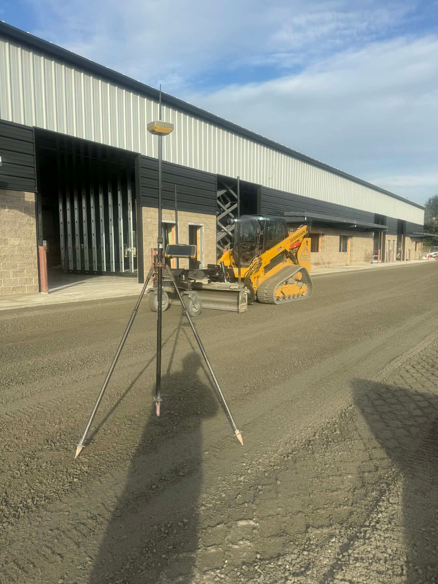 Yellow bulldozer moving dirt at a construction site.