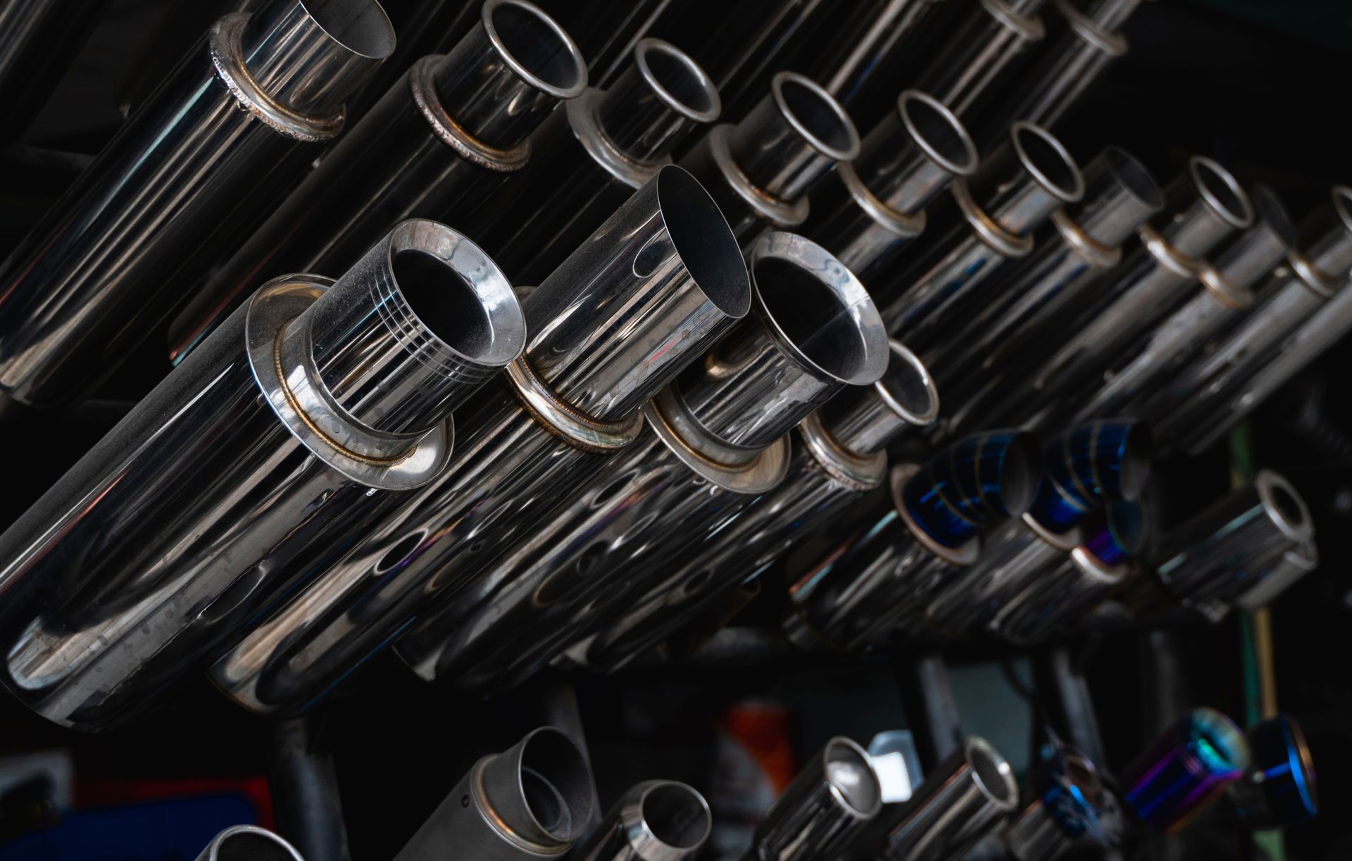 New and used motorcycle exhaust chrome pipes in a motorcykles shop or in service center.