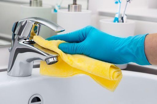 Man Cleaning the Faucet — NorthStar Cleaning & Property Services — Scottsdale, AZ