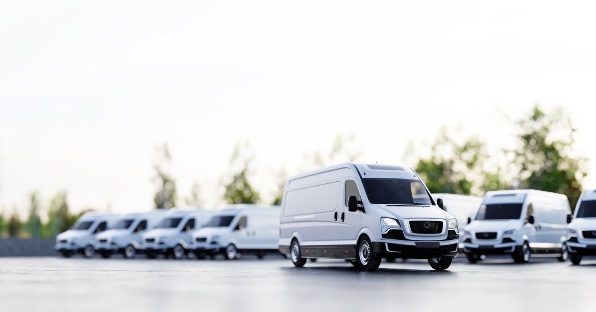A white van parked in the middle of a sleek concrete slab.