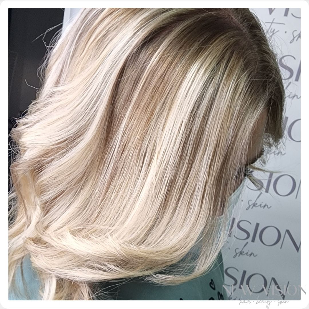 A close up of a woman 's blonde hair in a salon.