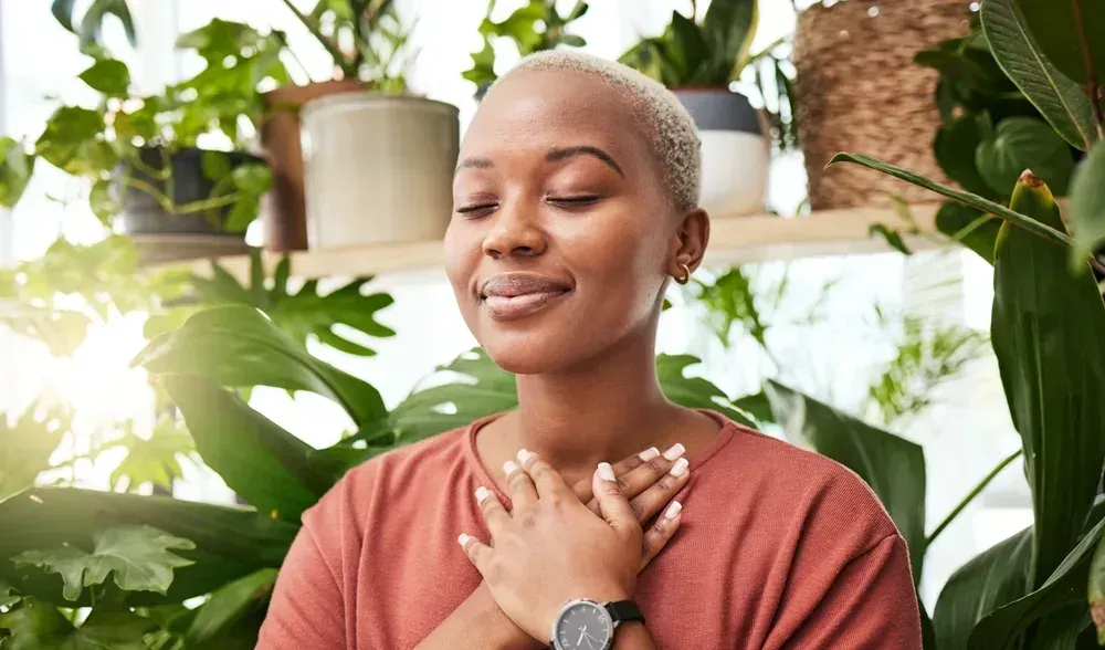 Hands of different skin tones clasped together, offering comfort and support.