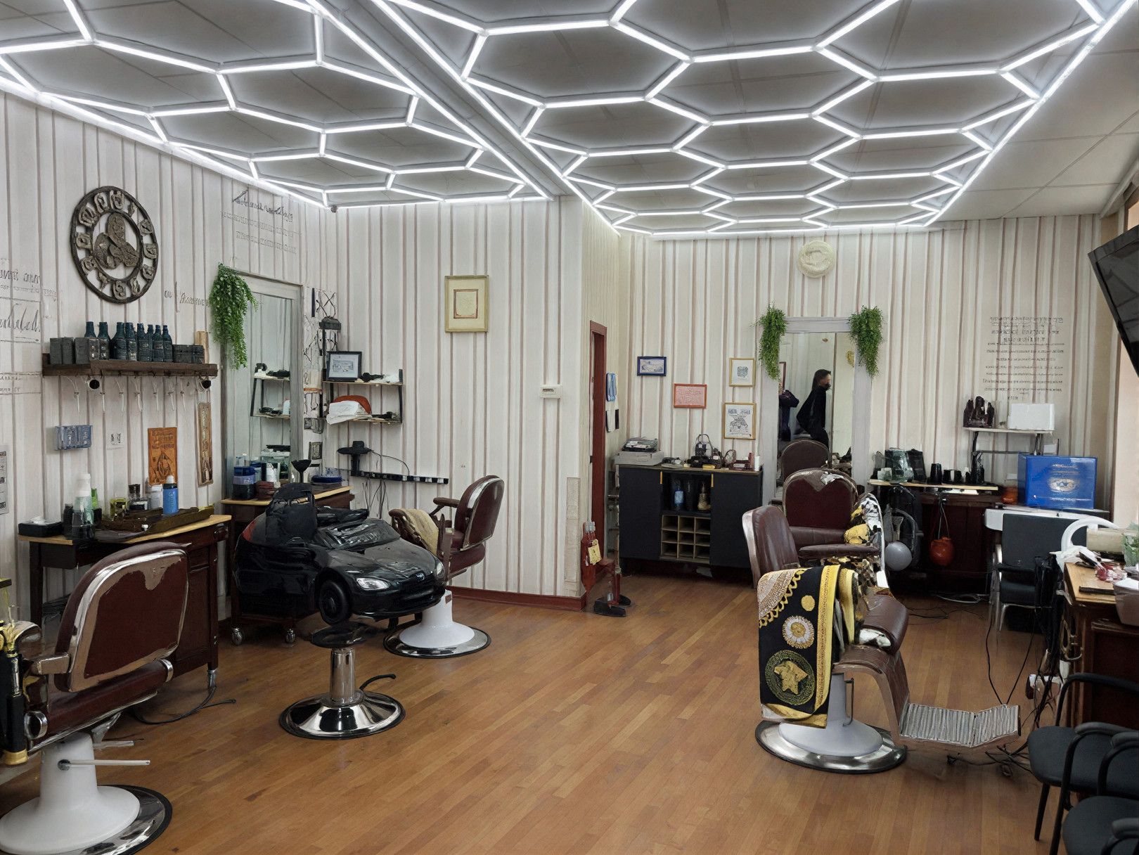 Barbershop interior with barber chairs, wood panel walls, honeycomb ceiling lights, and grooming products.