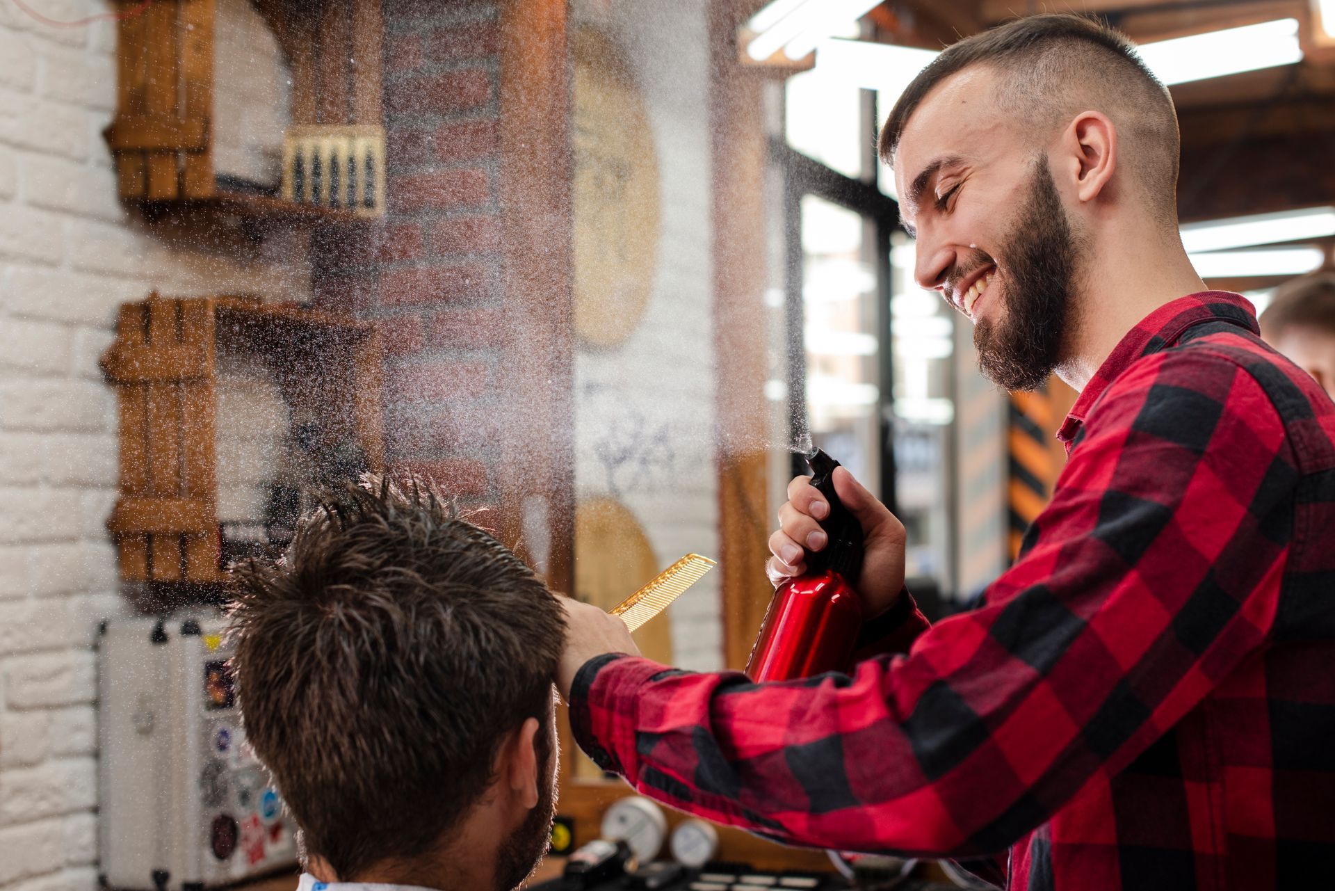 A man is getting his hair cut by a barber in a barber shop.