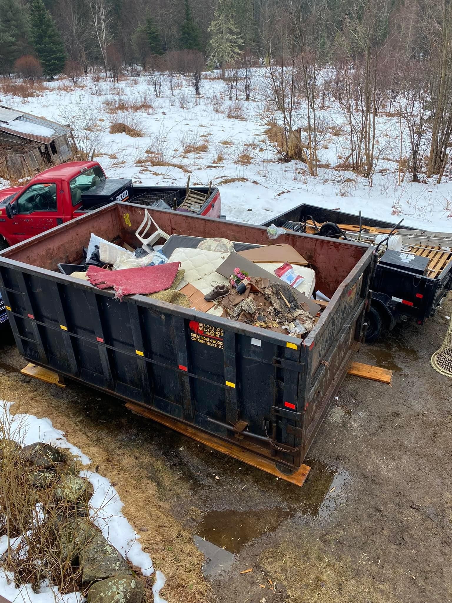 A commercial dumpster rental is filled with trash and is ready for dumpster pickup in Berlin, NH.