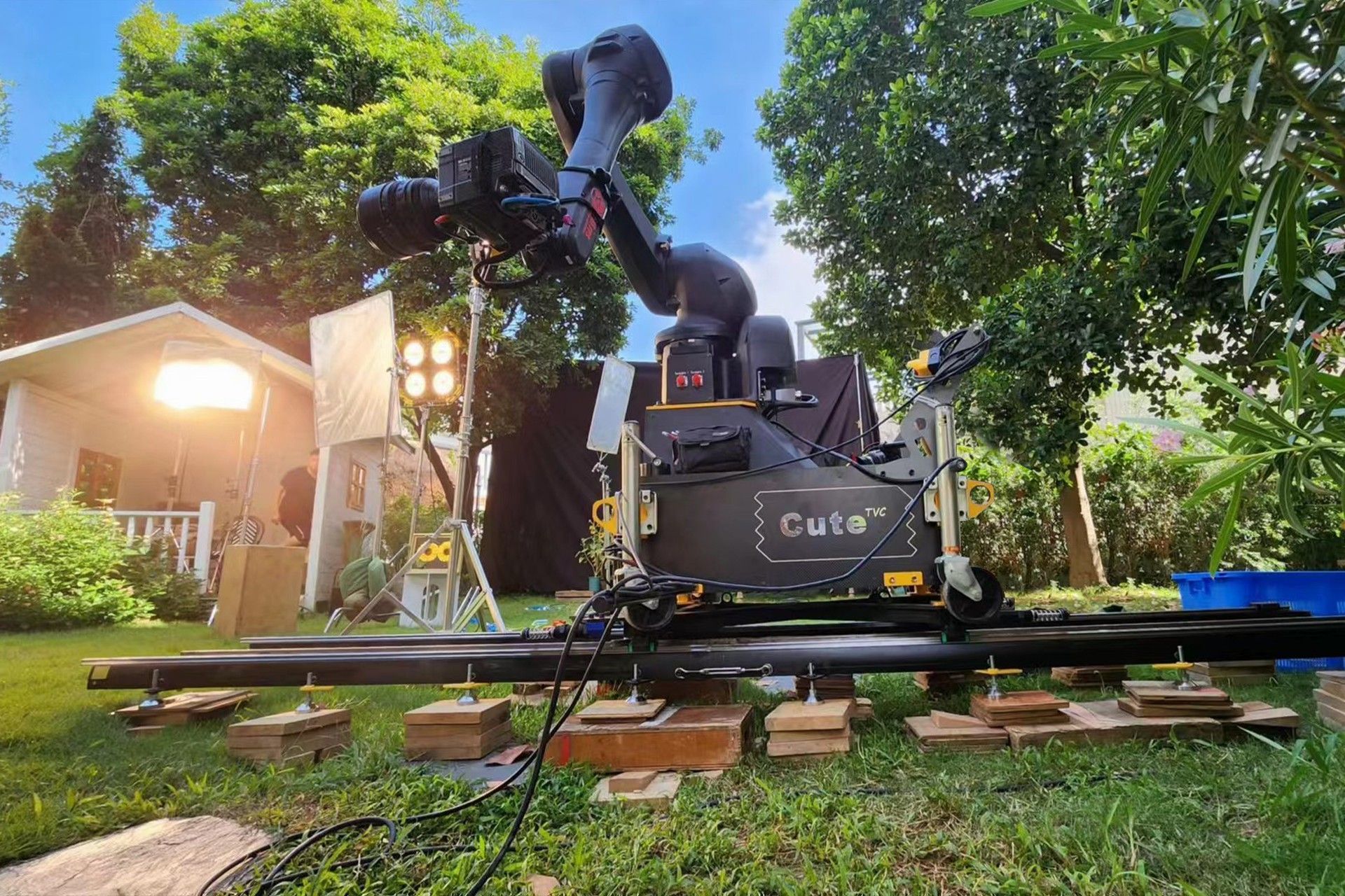 A camera is sitting on a sliding track in a yard.