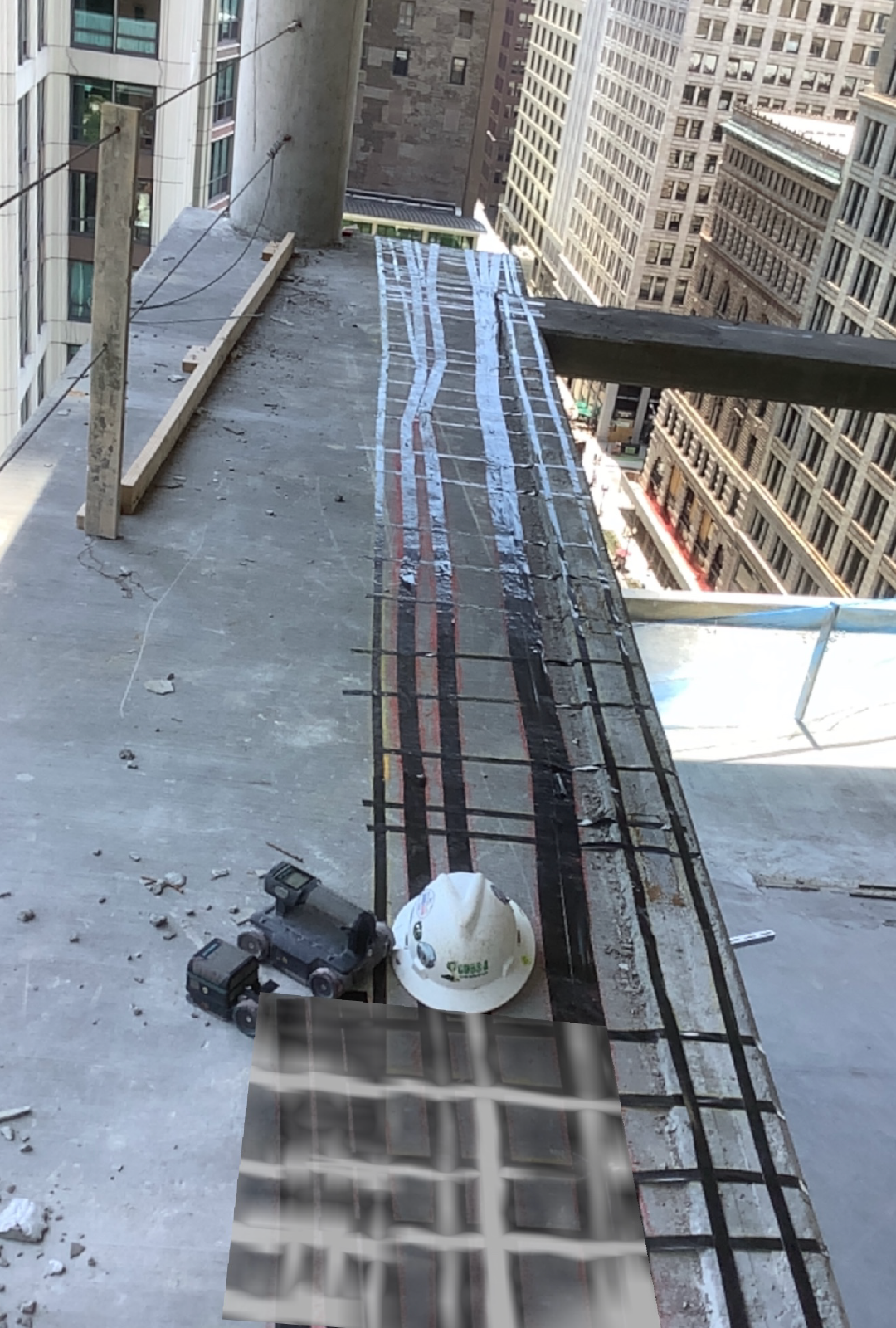 A hard hat is sitting on top of a concrete surface.