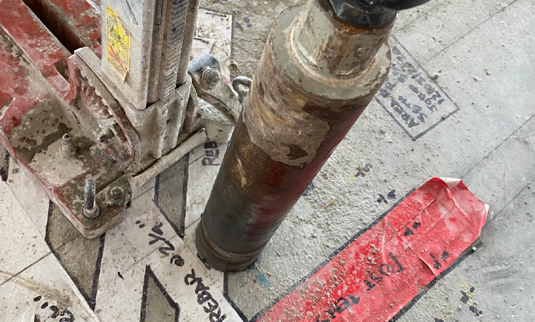 a concrete coring drill in action on a job site