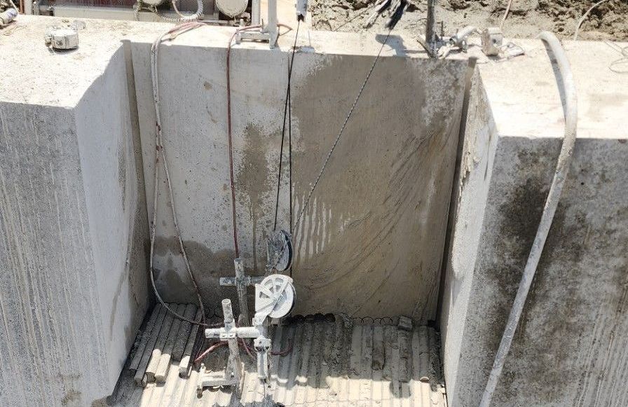 A concrete wall is being cut with a wire saw machine.