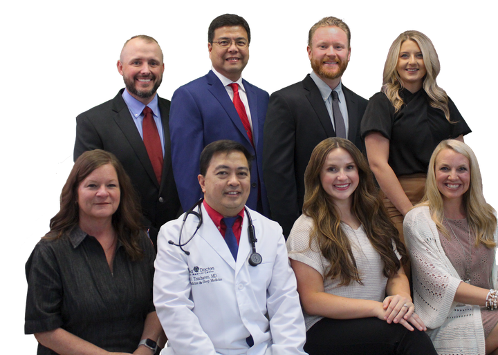 A group of doctors and nurses are posing for a picture.