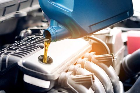 Refueling and Pouring Oil Quality into the Engine Motor Car Transmission and Maintenance Gear  — Peoria, IL — Trac Automotive