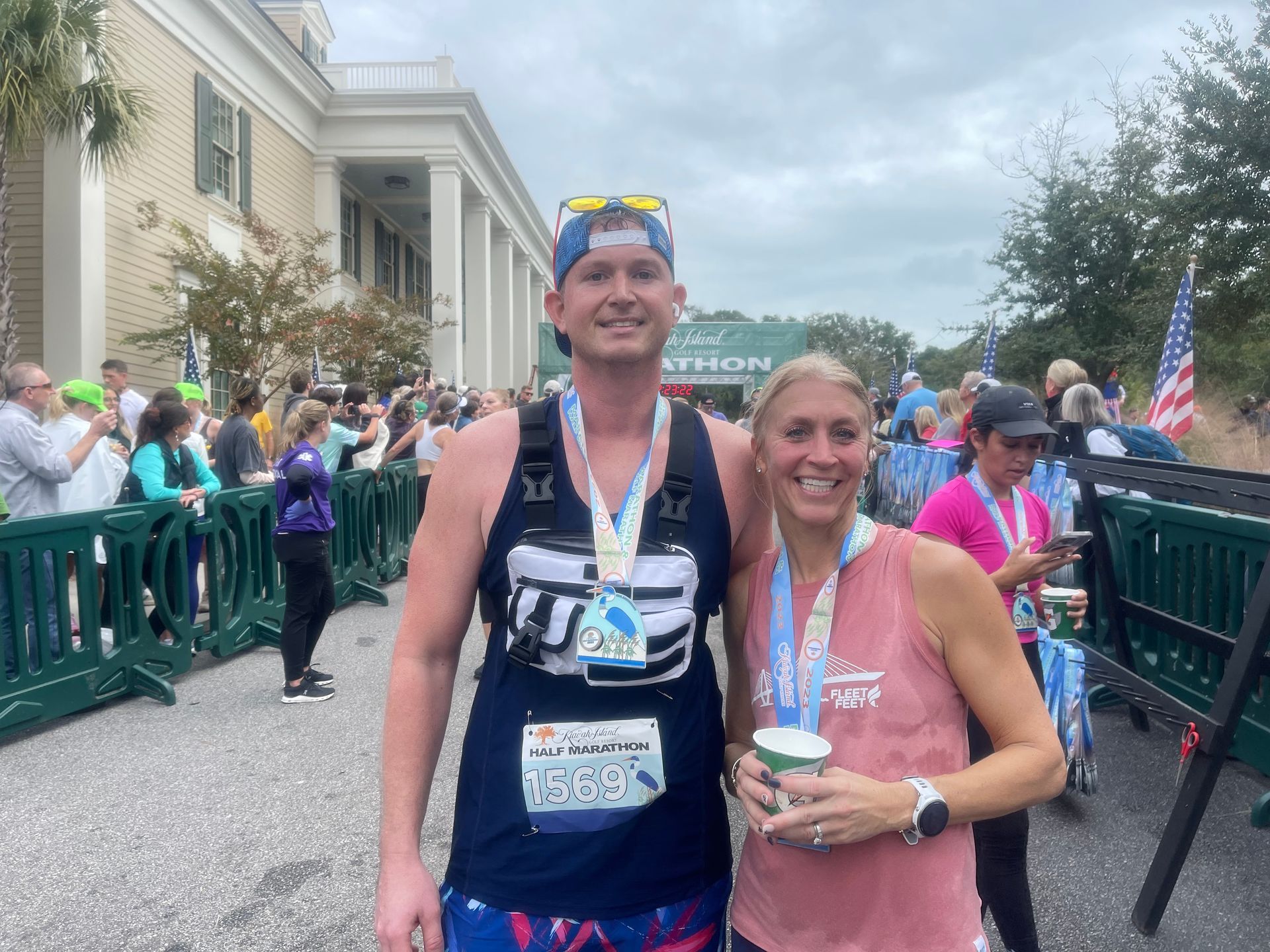 A man and a woman are posing for a picture at a marathon.