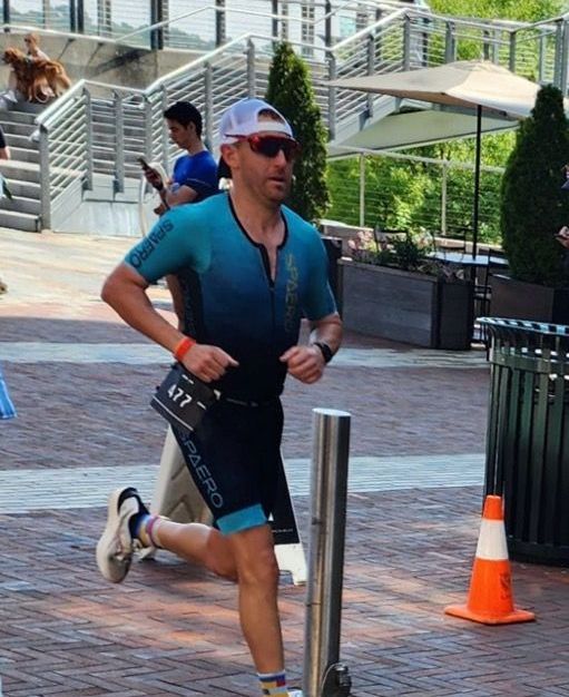 A man wearing sunglasses and a shirt that says palermo is running