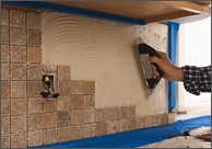 Person Adding Tile to Wall — Halifax, NC — Doug’s Tile Company