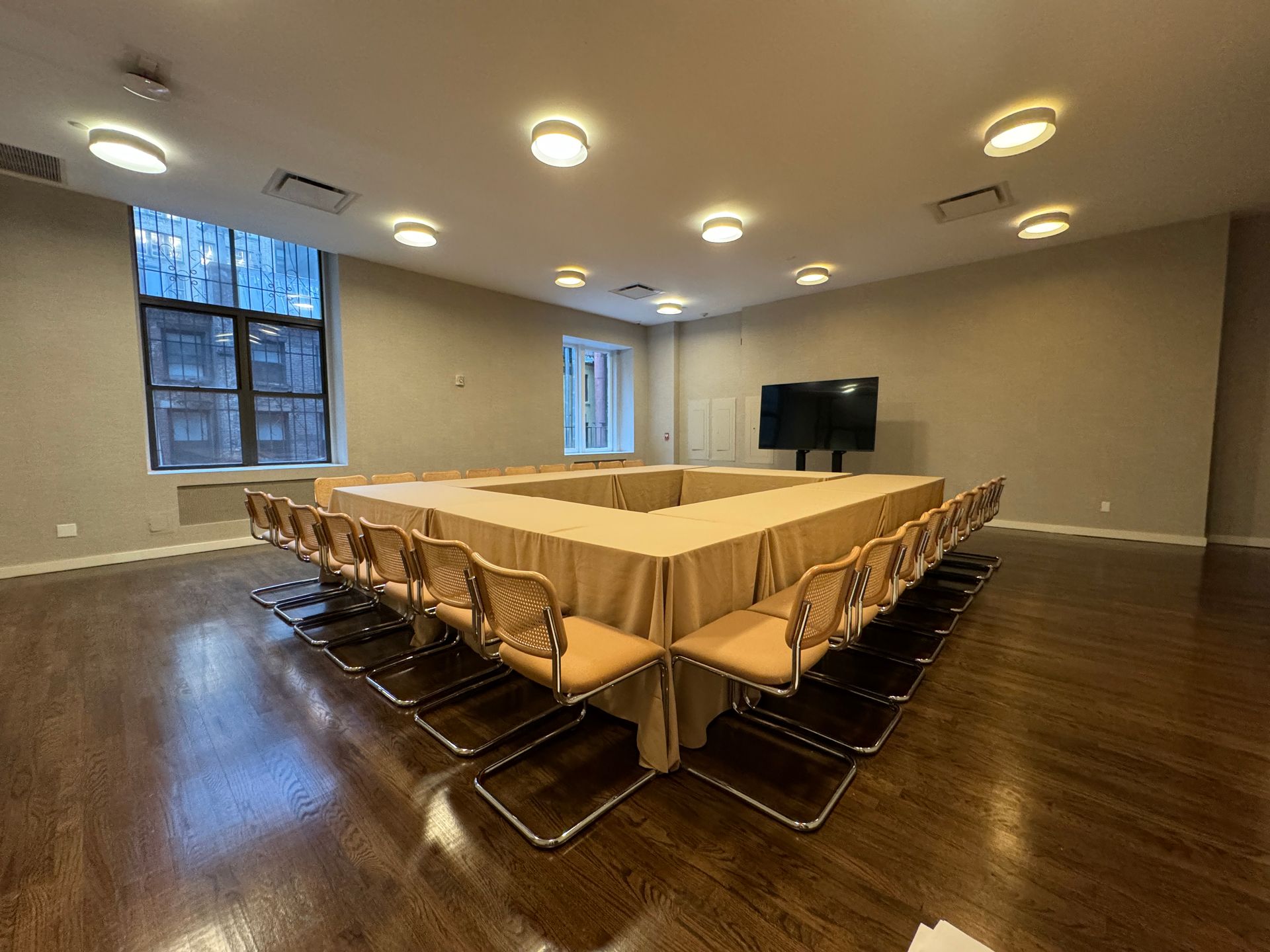 A large conference room with a long table and chairs.
