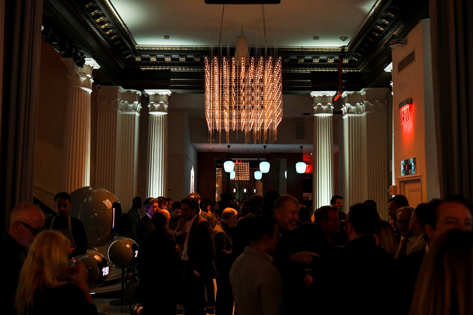 A snowy winter scene with an ice rink, small wooden stalls, and trees strung with lights.