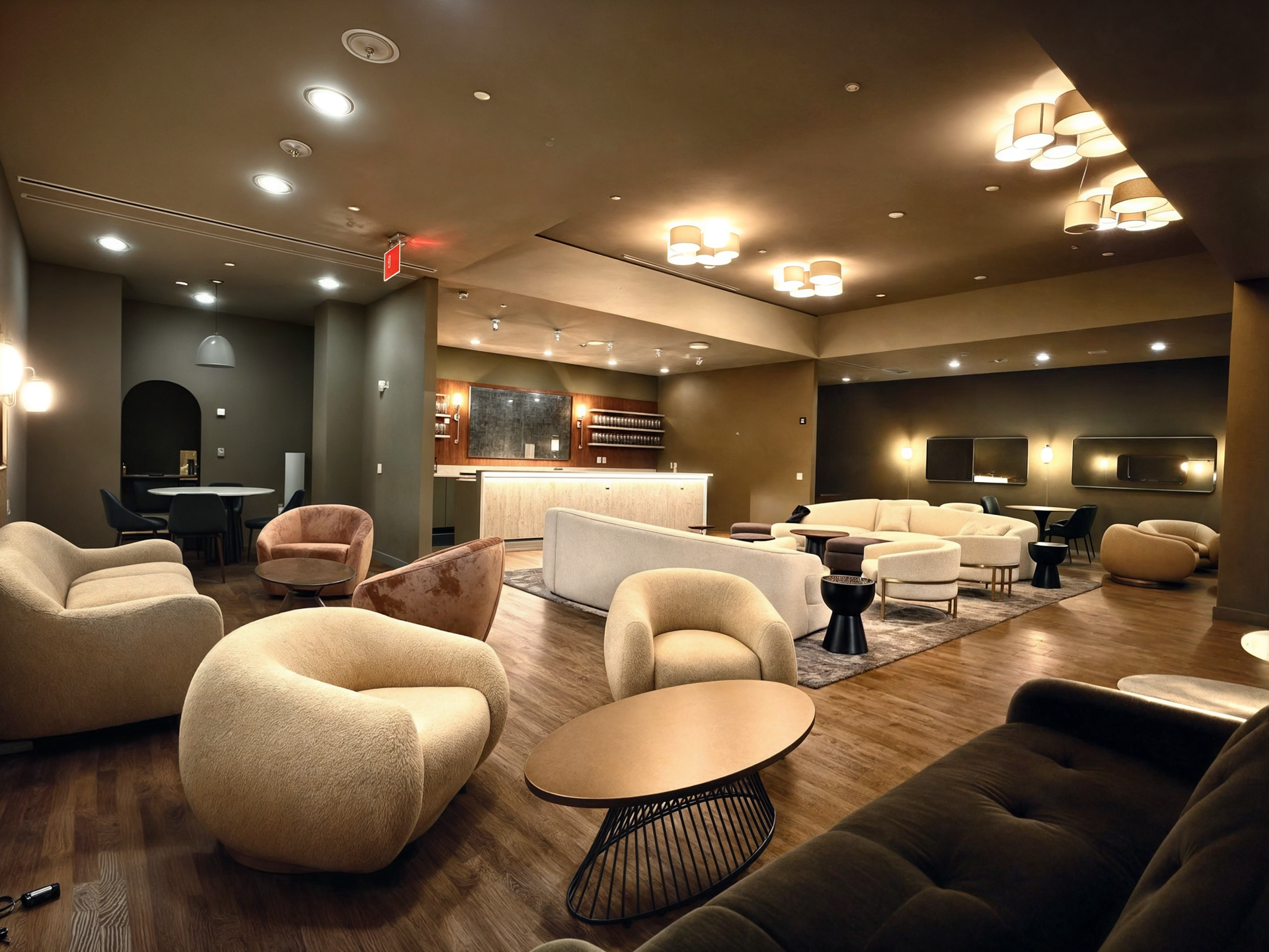 A living room with a couch , chairs and tables