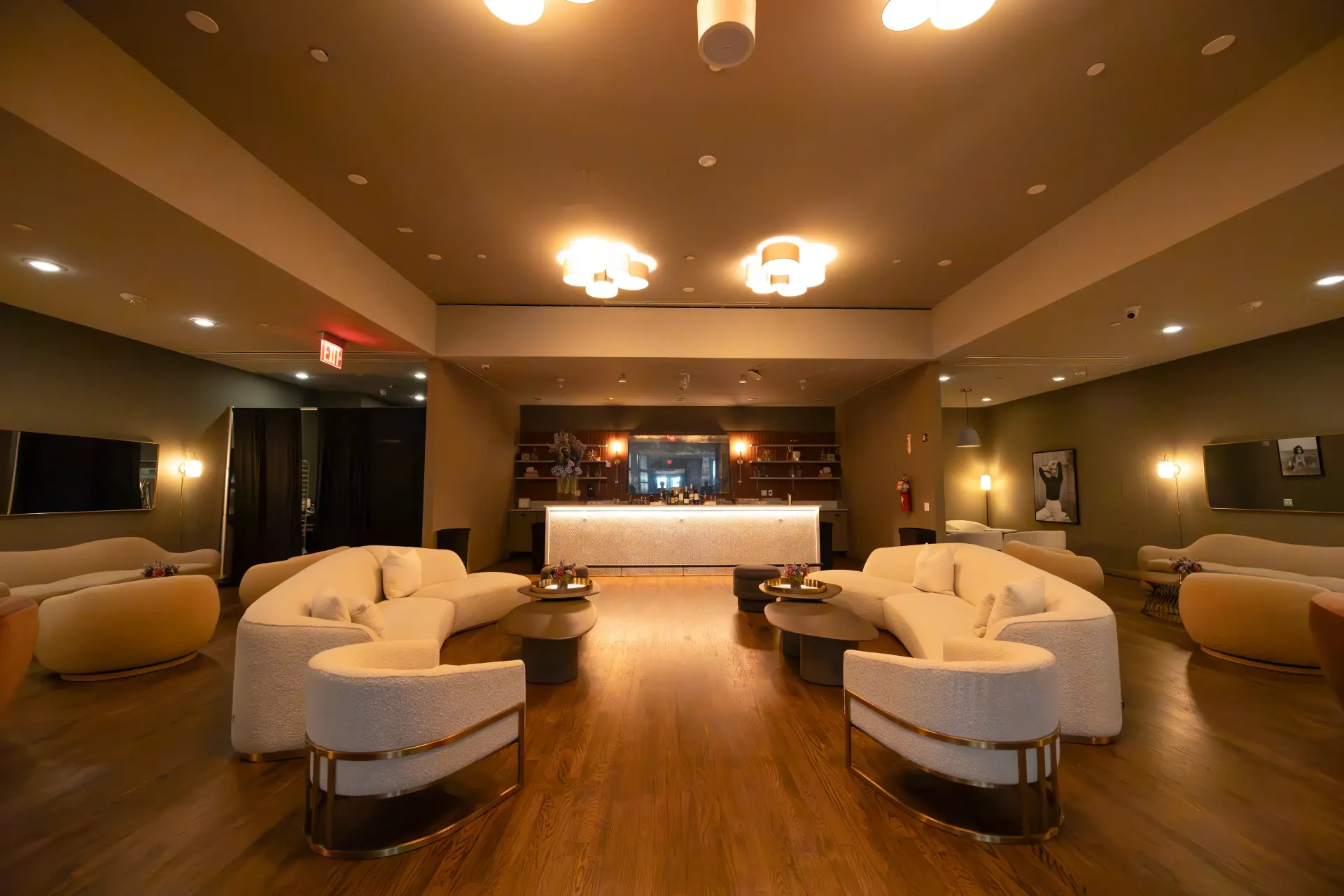 Couple in formal attire, smiling on a carousel, festive Christmas lights in the background.