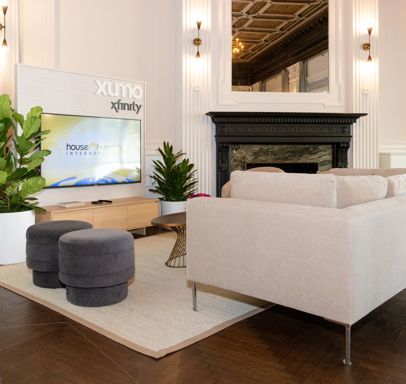 a living room with a xfinity sign on the wall