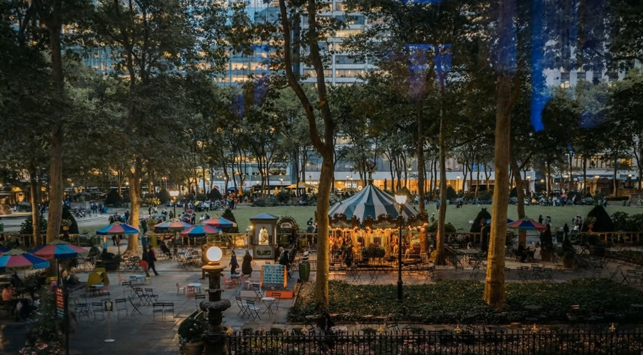 A blurry picture of a park at night with a carousel in the middle of it.