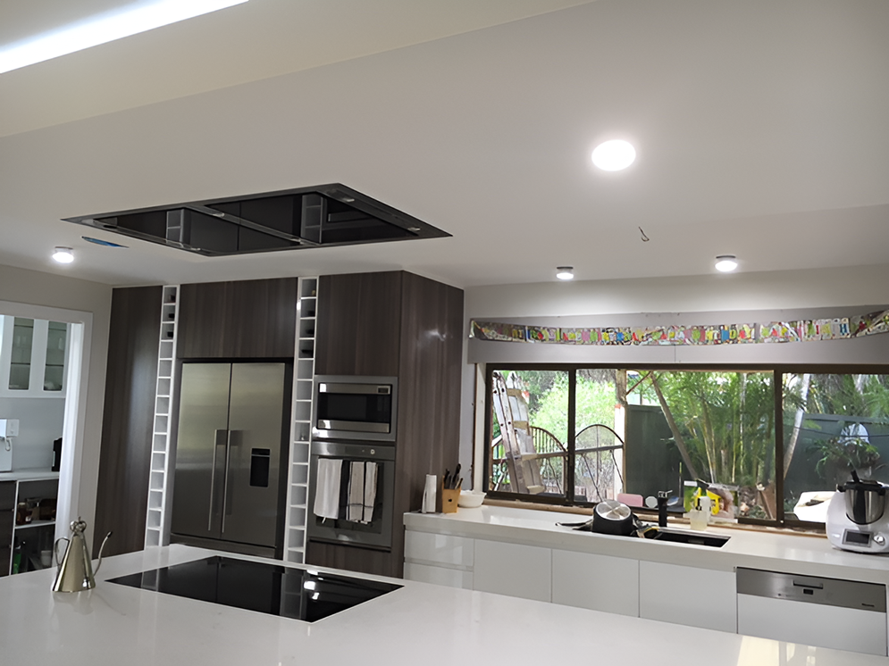 A Kitchen With a Stove Top Oven and a Refrigerator — Coppo's Electrical in Hope Island, QLD