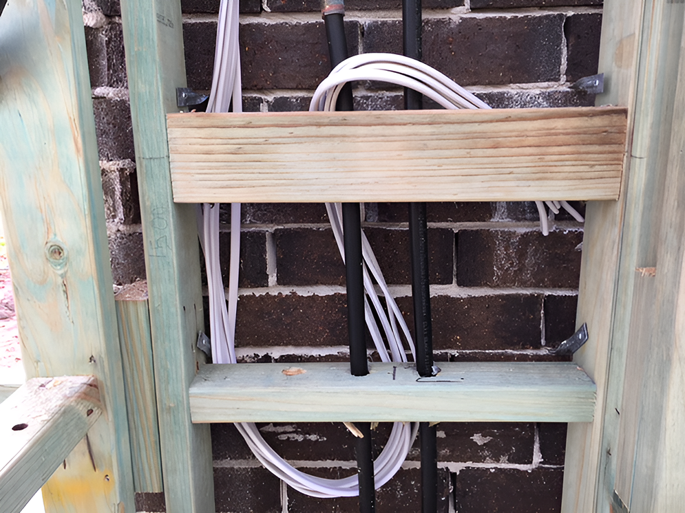A Brick Wall With Wires Coming Out of It — Coppo's Electrical in Runaway Bay, QLD