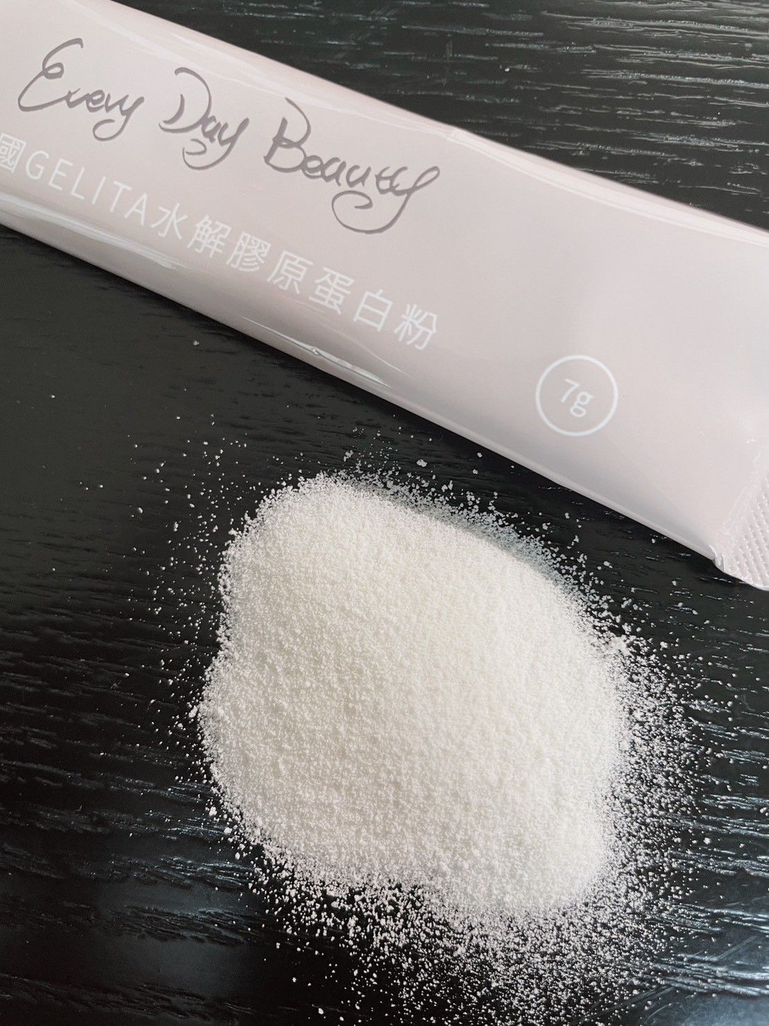 White powder spilled next to a light pink packet labeled 