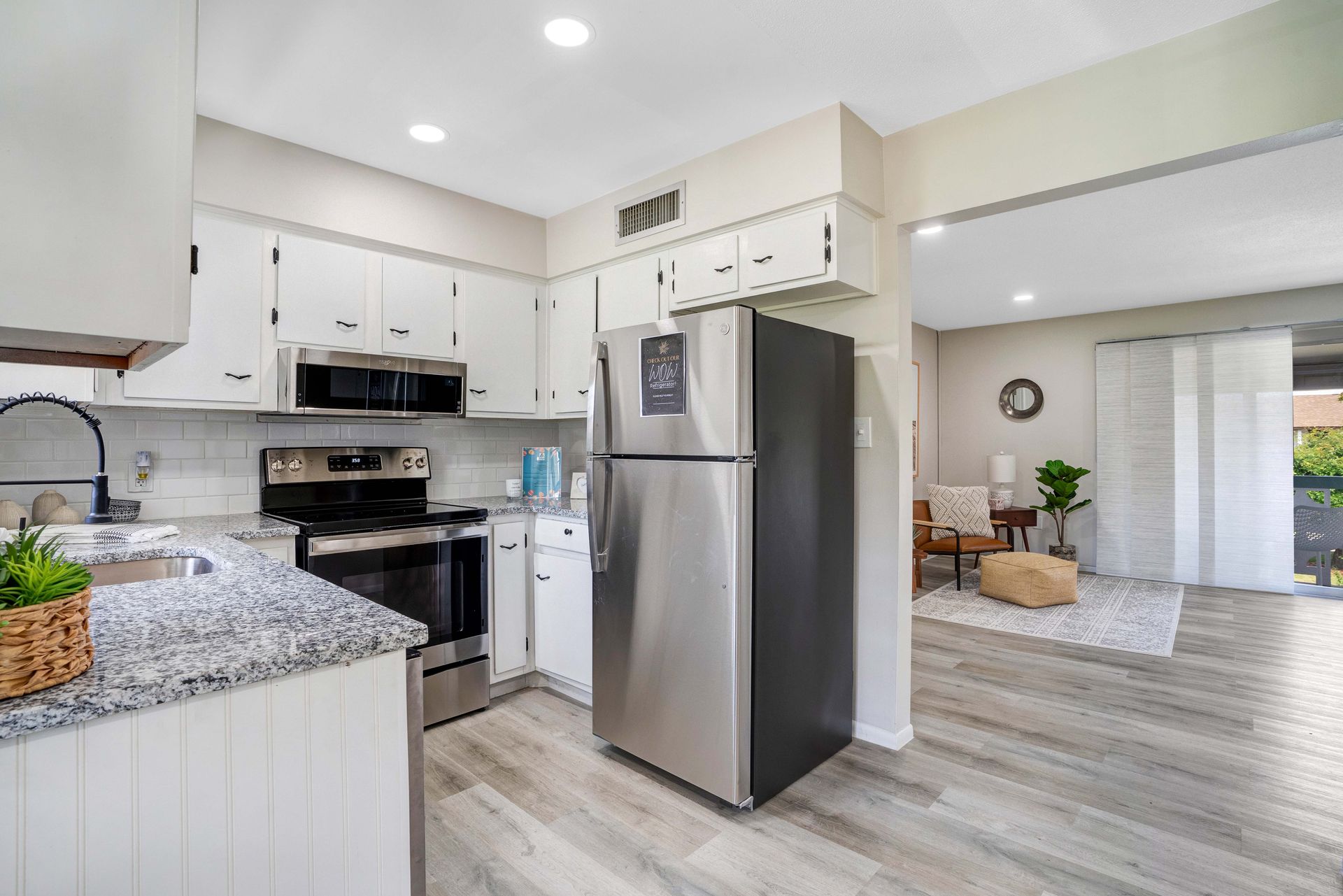 A kitchen with stainless steel appliances and a stainless steel refrigerator.