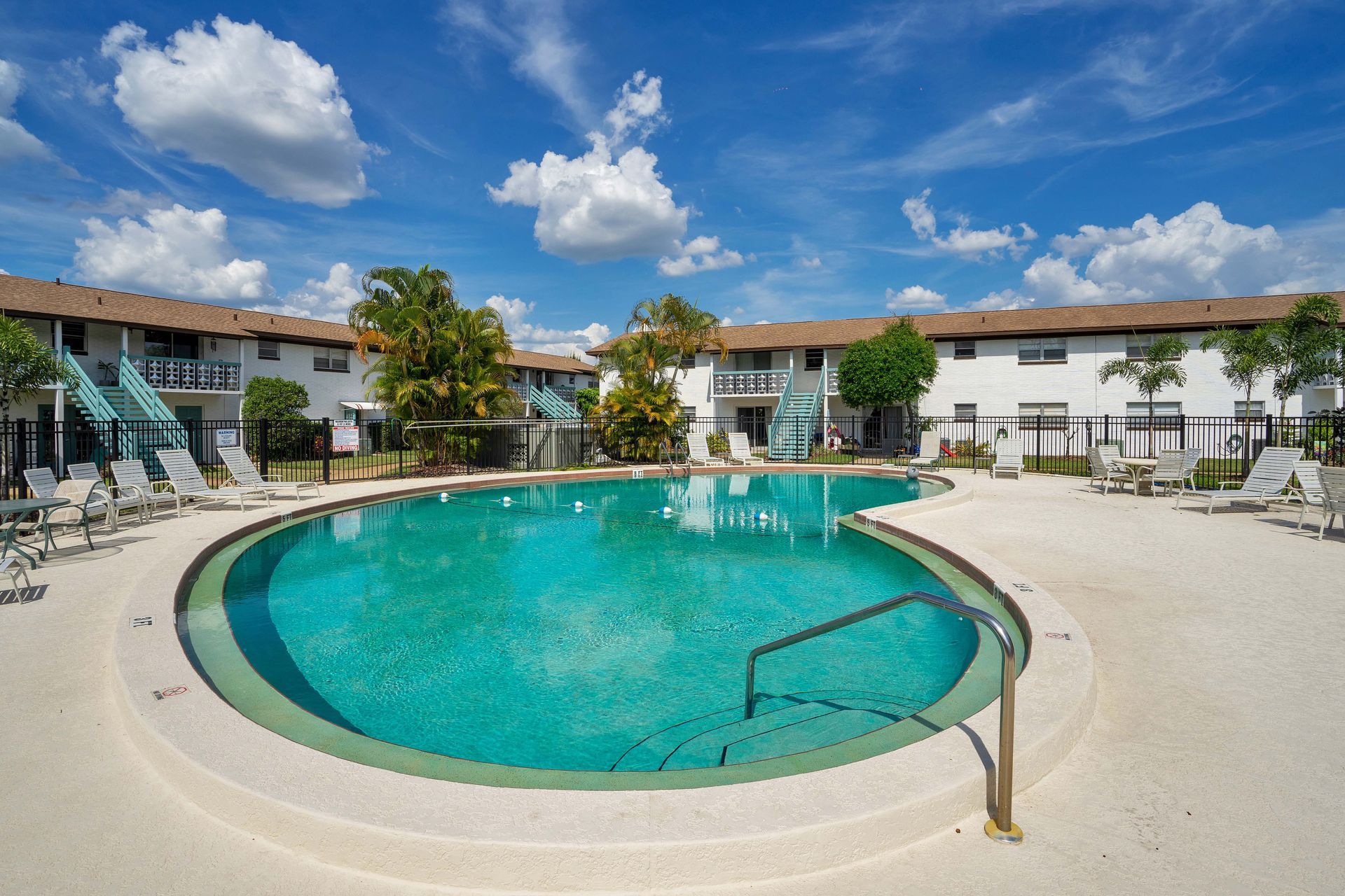 A large swimming pool in front of a building.