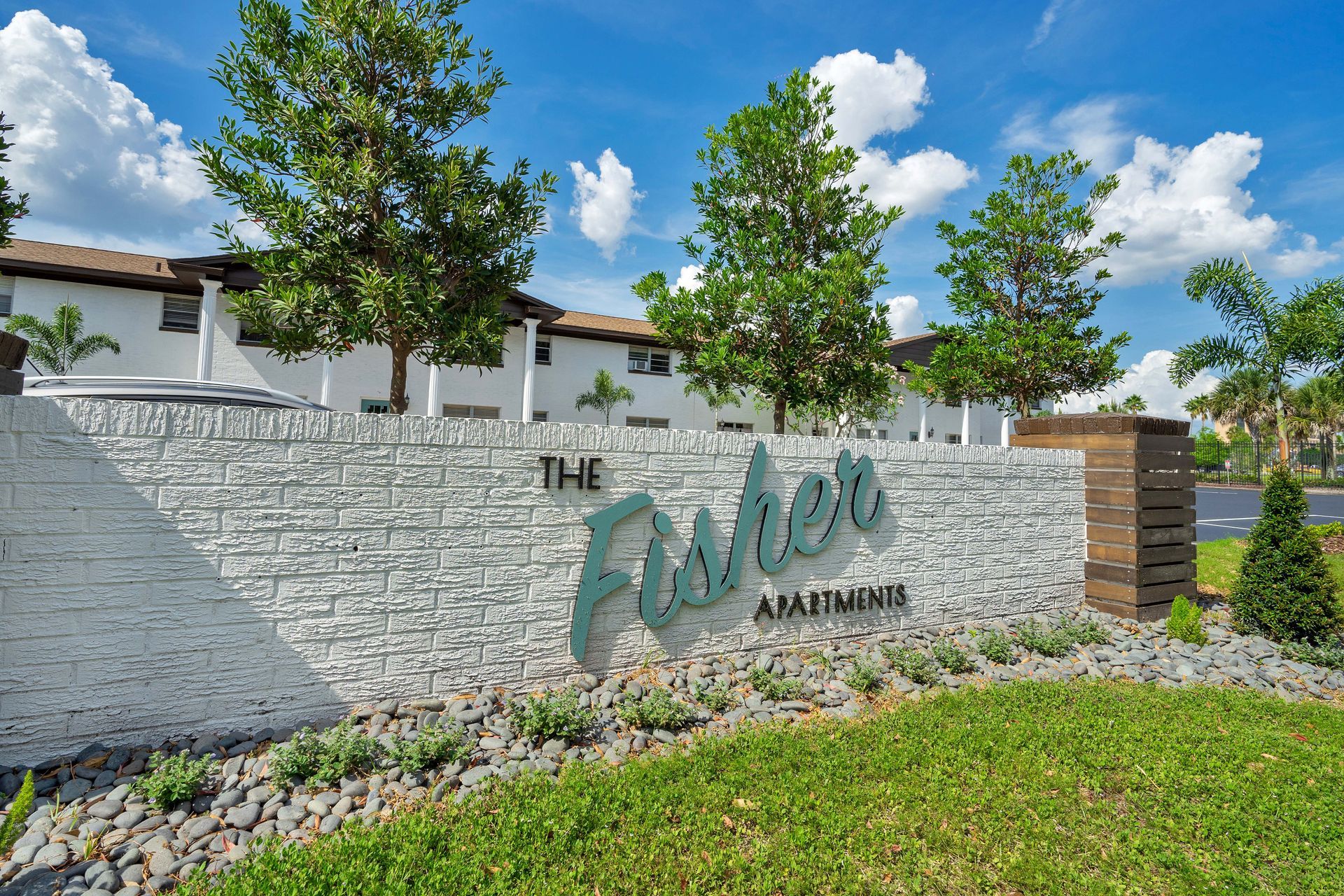 A brick wall with a sign that says the fisher apartment