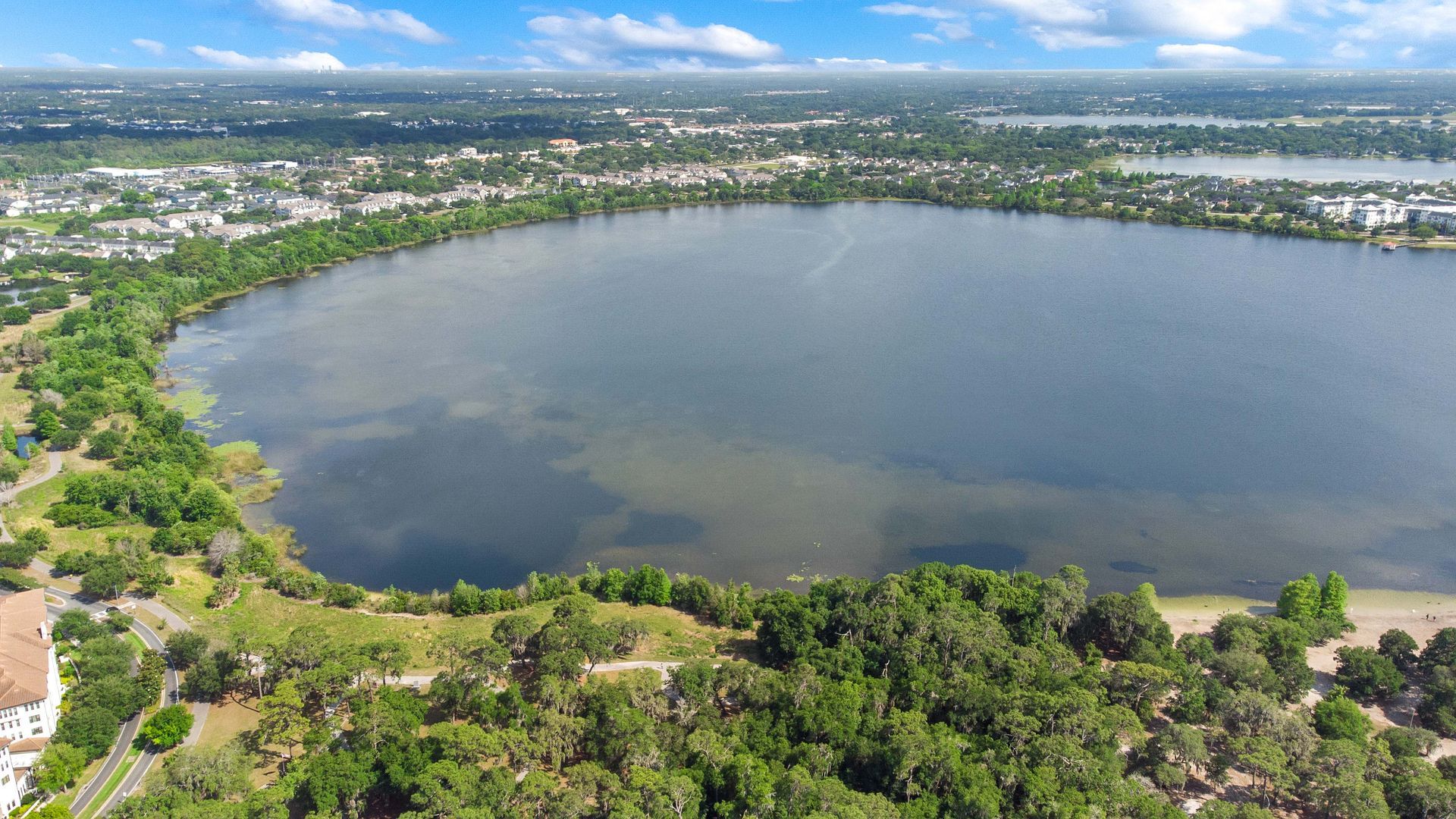 An aerial view of a large lake surrounded by trees.