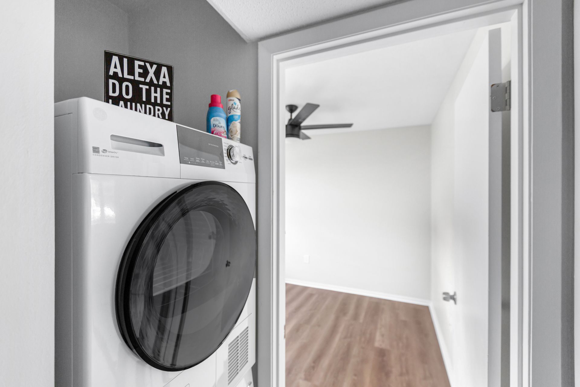 A washer and dryer are in a laundry room next to a door.