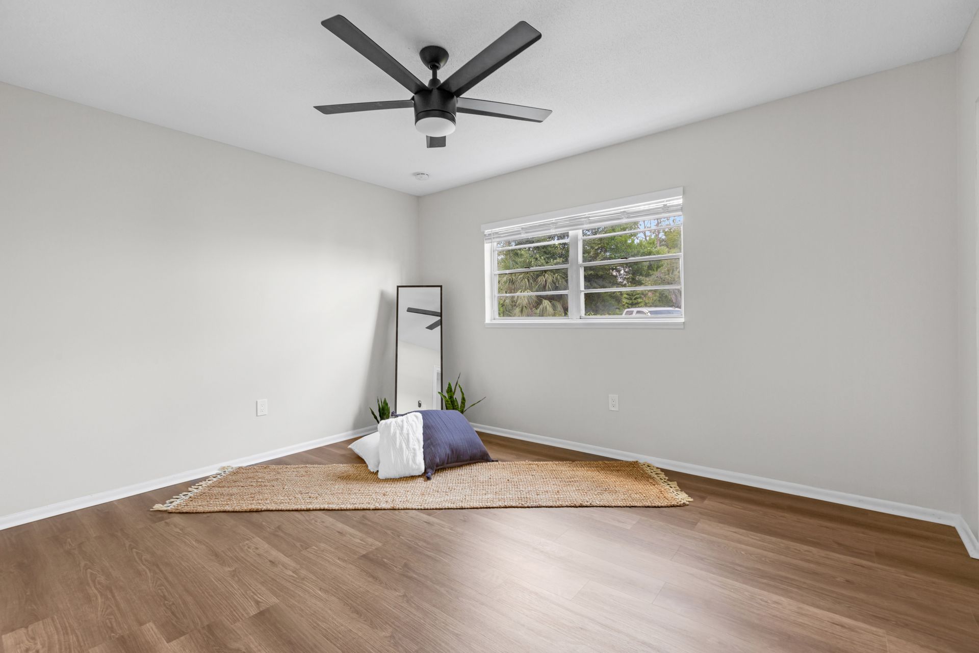 There is a ceiling fan in the corner of the room.