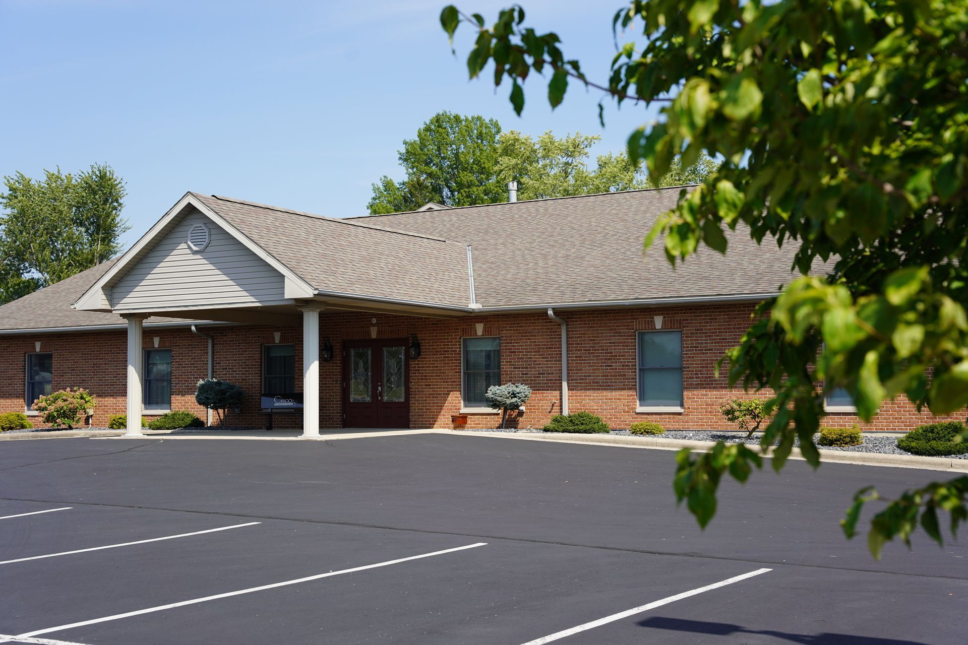 A large building with a parking lot in front of it.