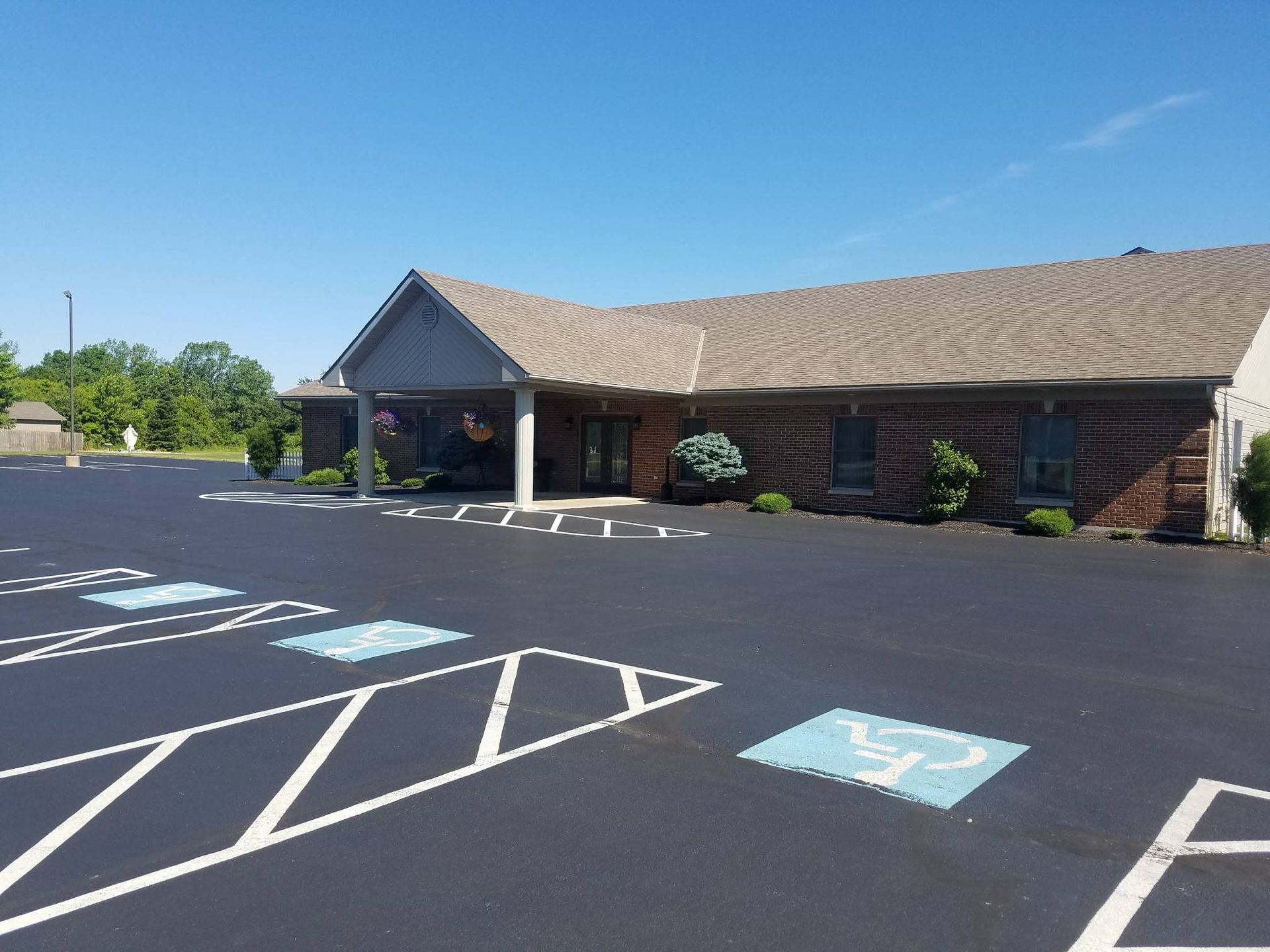 A large building with a parking lot in front of it.