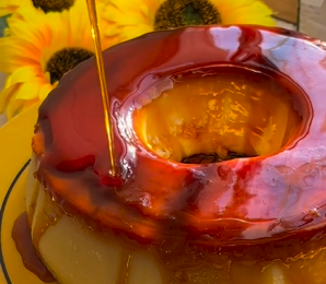 Um close de um bolo com calda sendo despejada nele