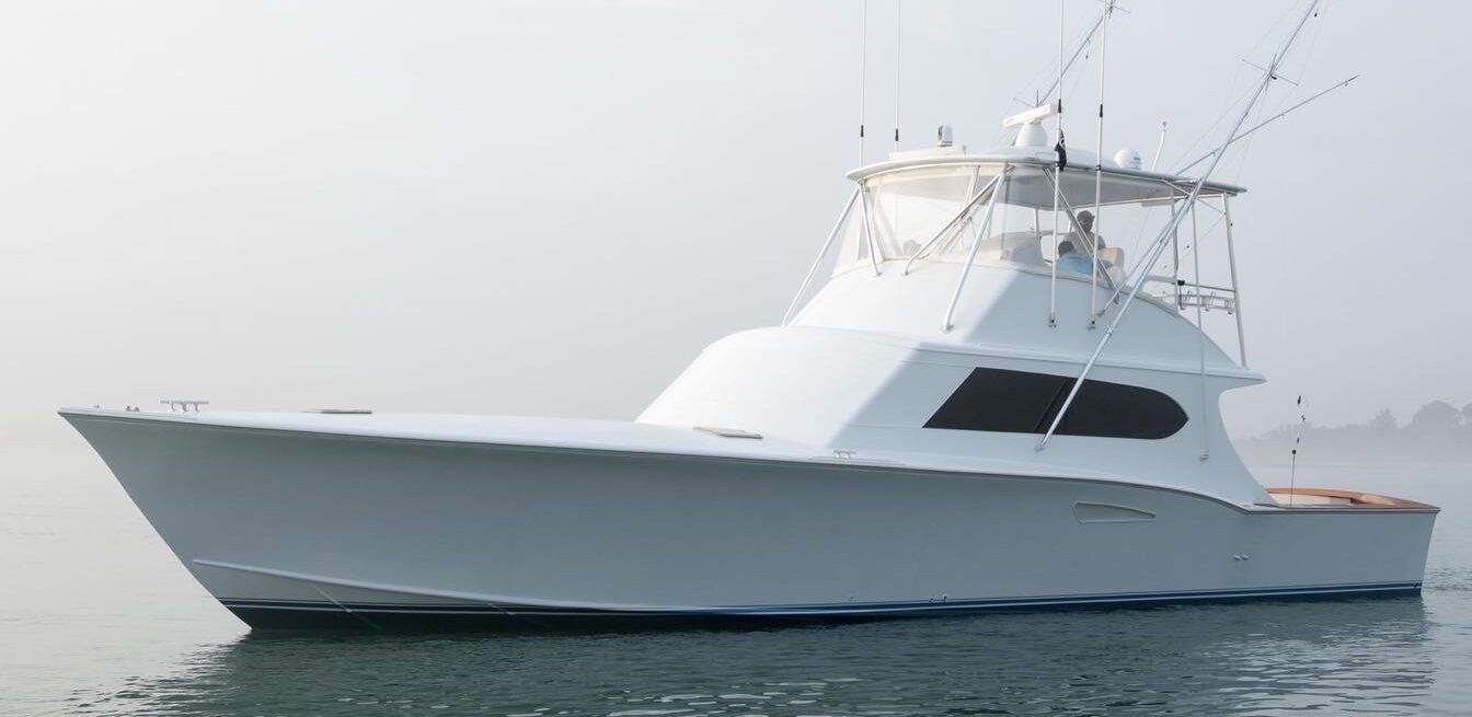 A large white boat is floating on top of a body of water