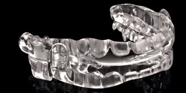 Close up image of a clear oral appliance used for sleep apnea therapy.