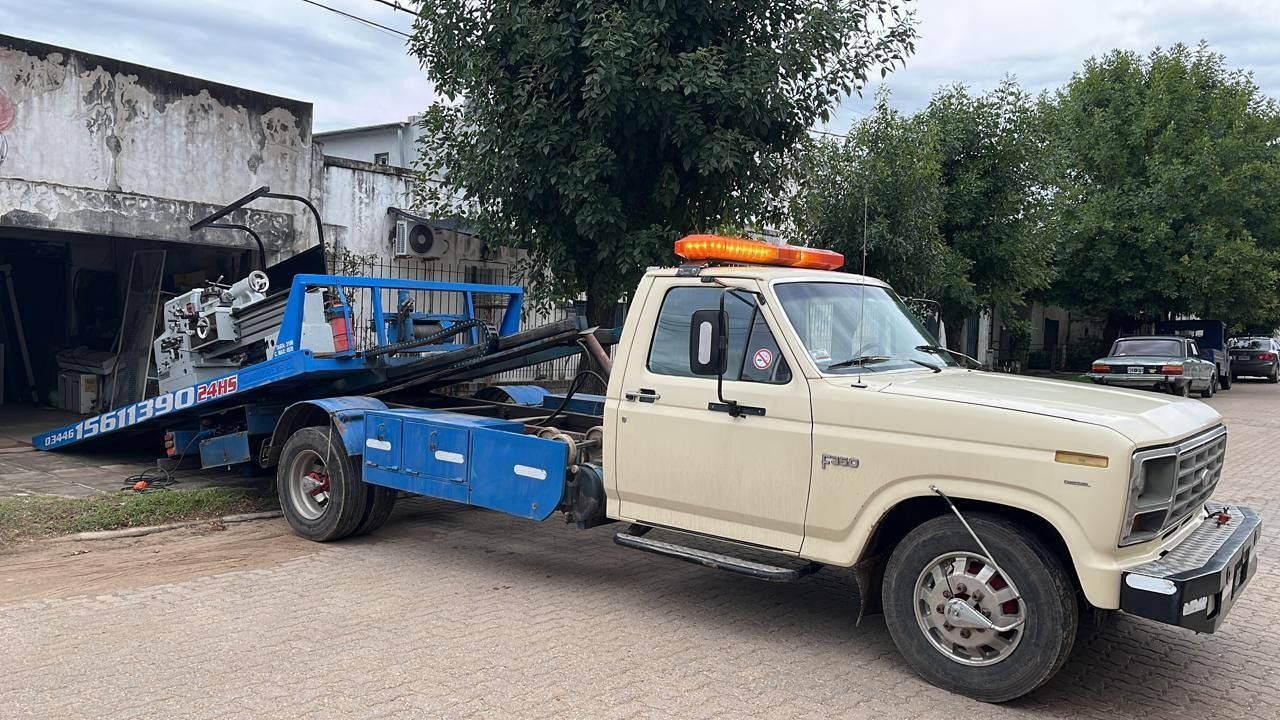 Una grúa está estacionada al costado de la carretera al lado de un edificio.